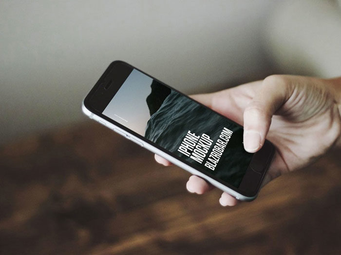 iphone-in-hand-mockup-700x525 Hand holding iPhone mockup templates you can download now