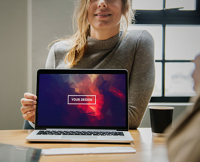 Lady-Showing-MacBook-Mockup-–-Free-PSD Free Macbook mockup examples to download now