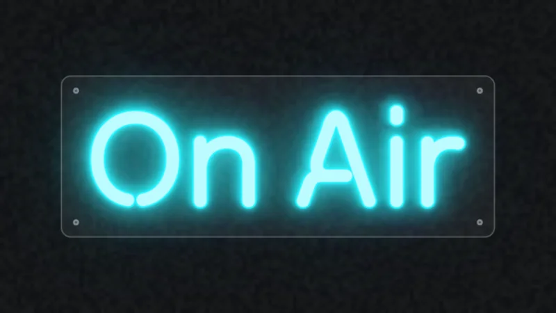 Cyan neon sign reading On Air on a clear acrylic panel with standoffs